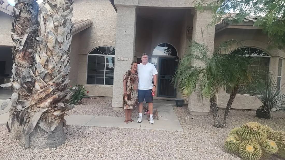 Happy clients outside their new home